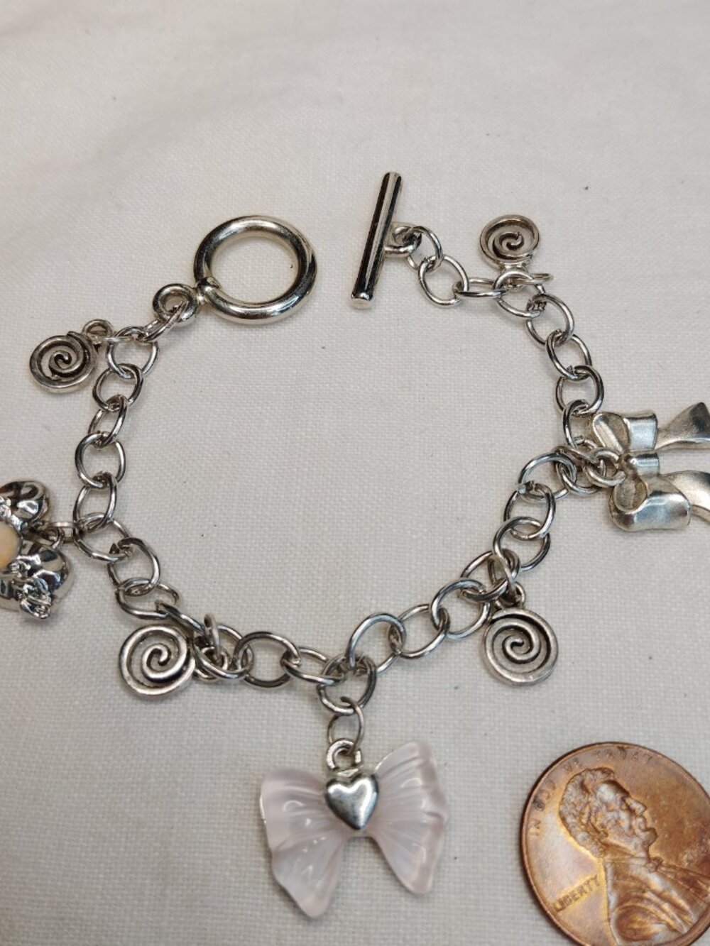 Vintage‑Style Silver‑Tone Charm Bracelet – Pink Butterfly, Bow & Spiral Accents